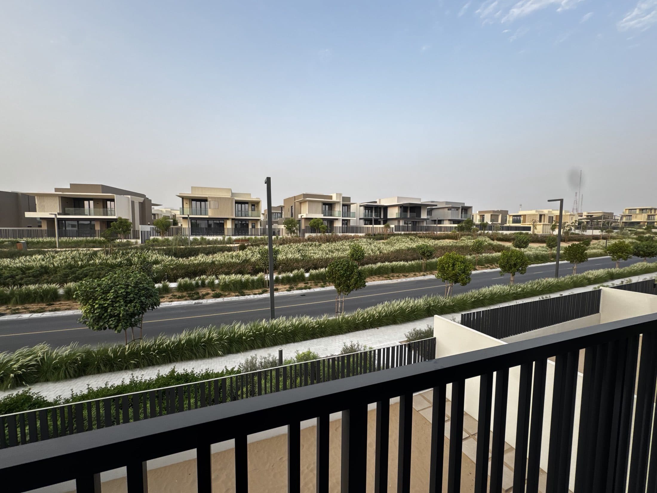 Contemporary villas beside a landscaped street in Jebel Ali Village