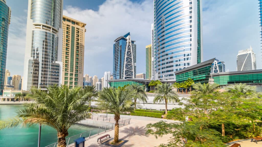 Residential buildings covered with glass in Jumeirah Lake Towers reflected in water in Dubai 2 1