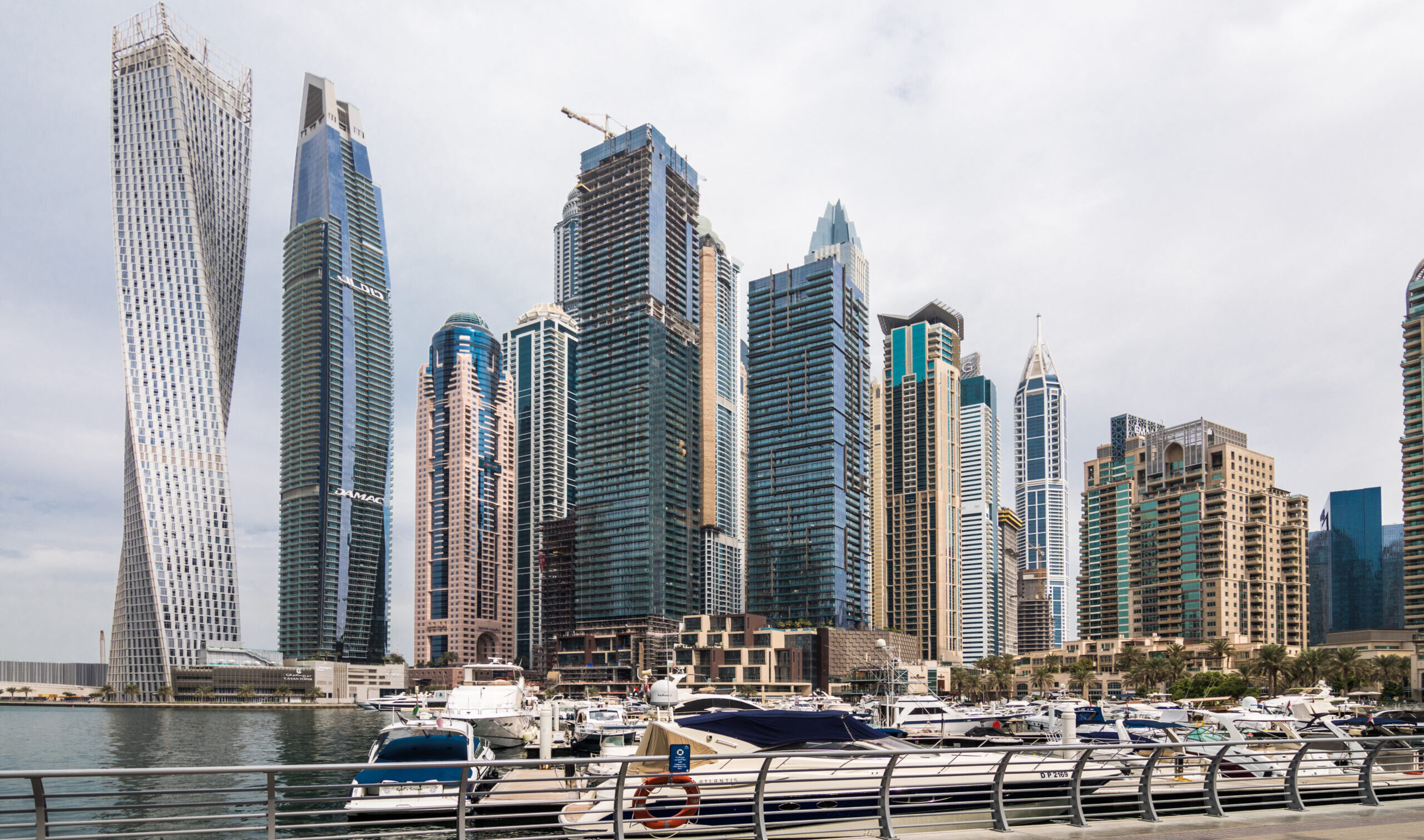 Harbour Promenade waterfront at Dubai Creek Harbour with EMAAR residential towers and Downtown Dubai skyline in the background