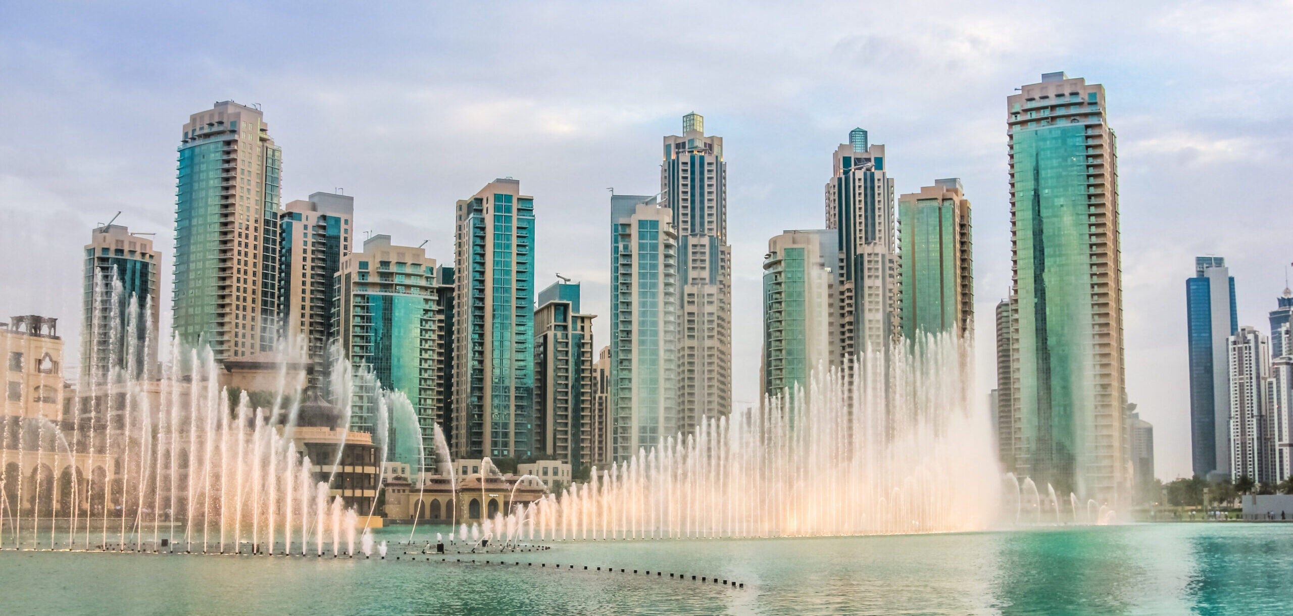 Discover Dubai off-plan properties investment opportunities - Dubai Fountain on Burj Khalifa Lake with Downtown Dubai high-rise towers in the background