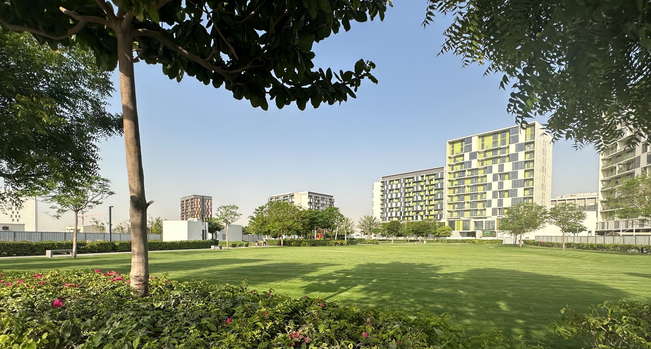 Central landscaped park and mid-rise residential buildings at Emaar South in Dubai South, UAE