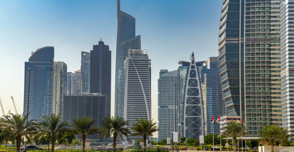Canal promenade at Jumeirah Lake Towers with high-rise residential buildings reflected in the water, Dubai