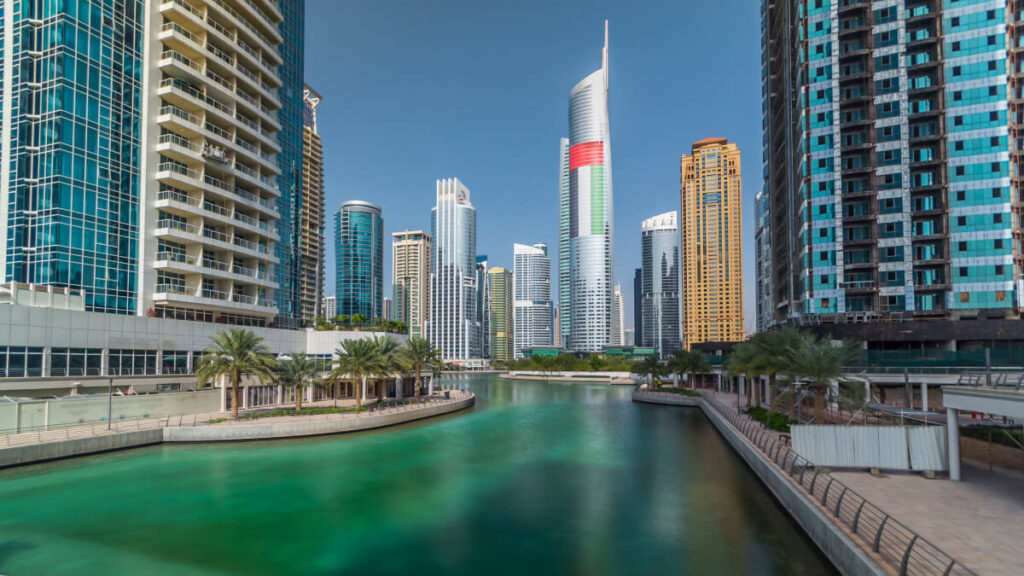 Residential buildings in Jumeirah Lake Towers reflected in water in Dubai 1 1