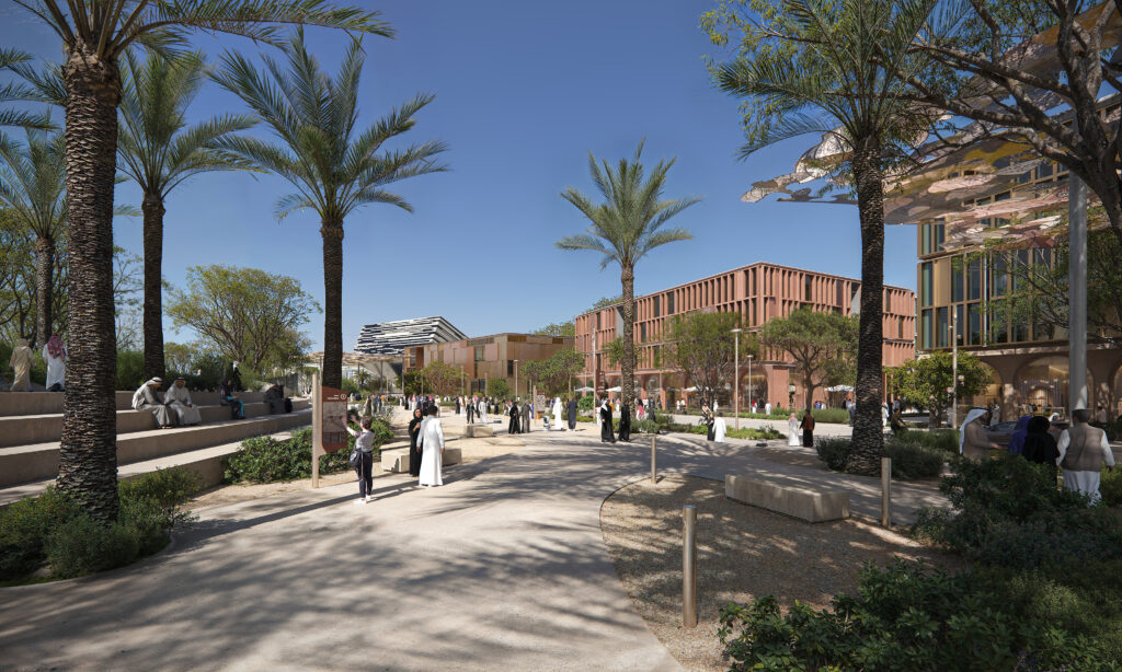 Shaded pedestrian boulevard in Expo Business District, Expo City Dubai, with modern buildings and landscaped greenery.